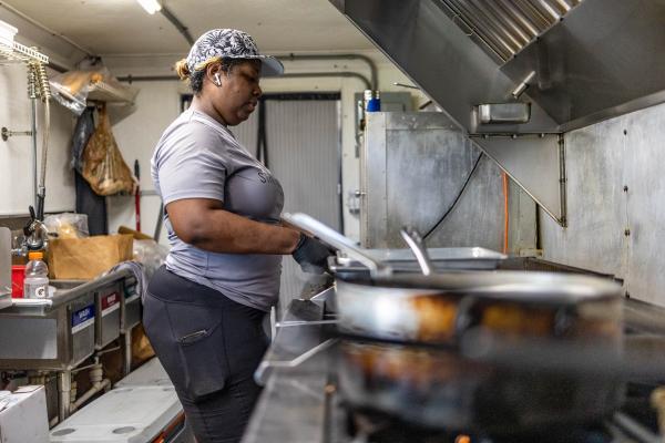 Felicia Reese, owner 22 Street Kitchen, gets food ready for customers