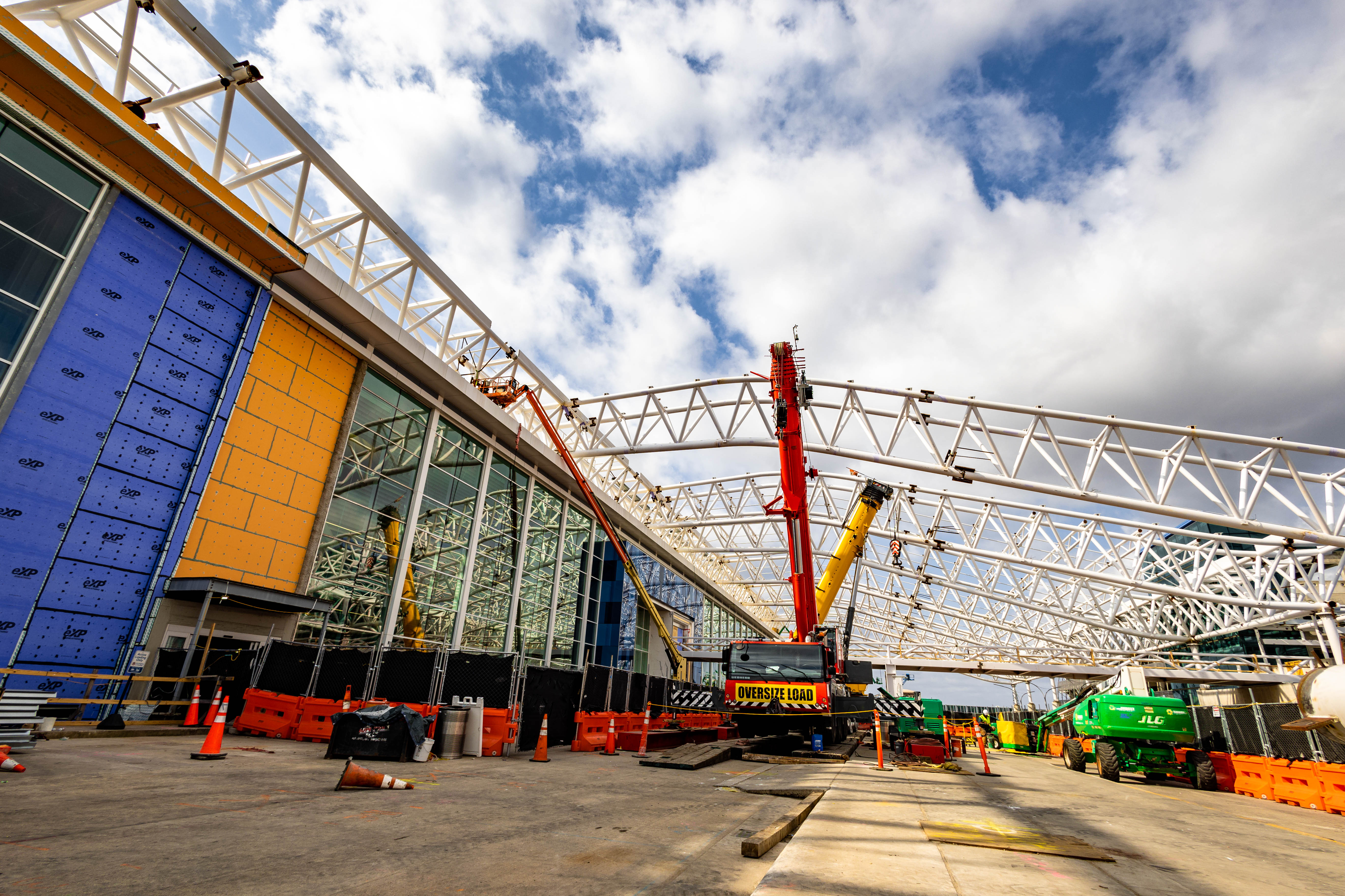 standing outside the terminal lobby the canopy of the upper roadway takes shape against a blue sky