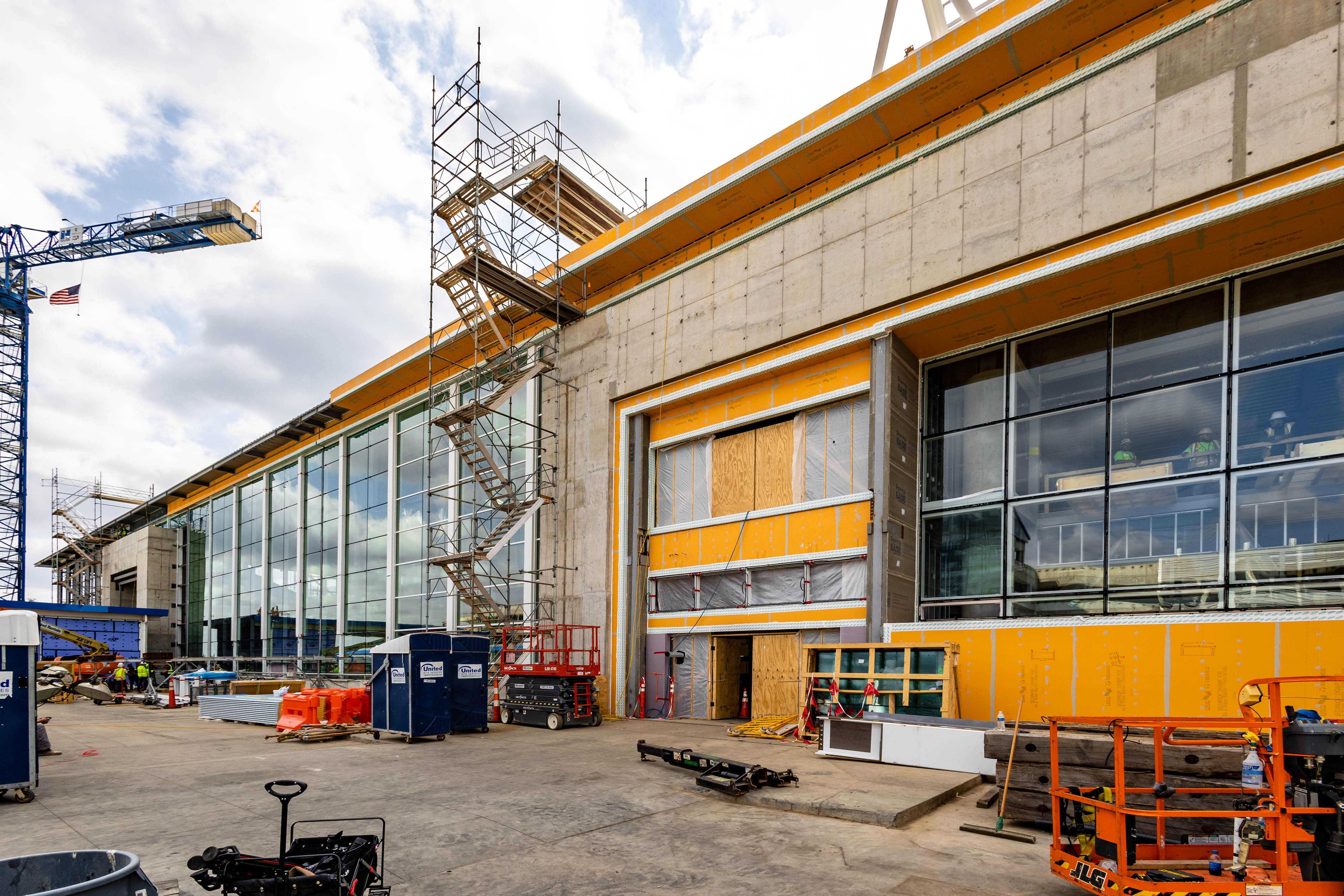 exterior of the terminal lobby expansion is framed by construction cranes