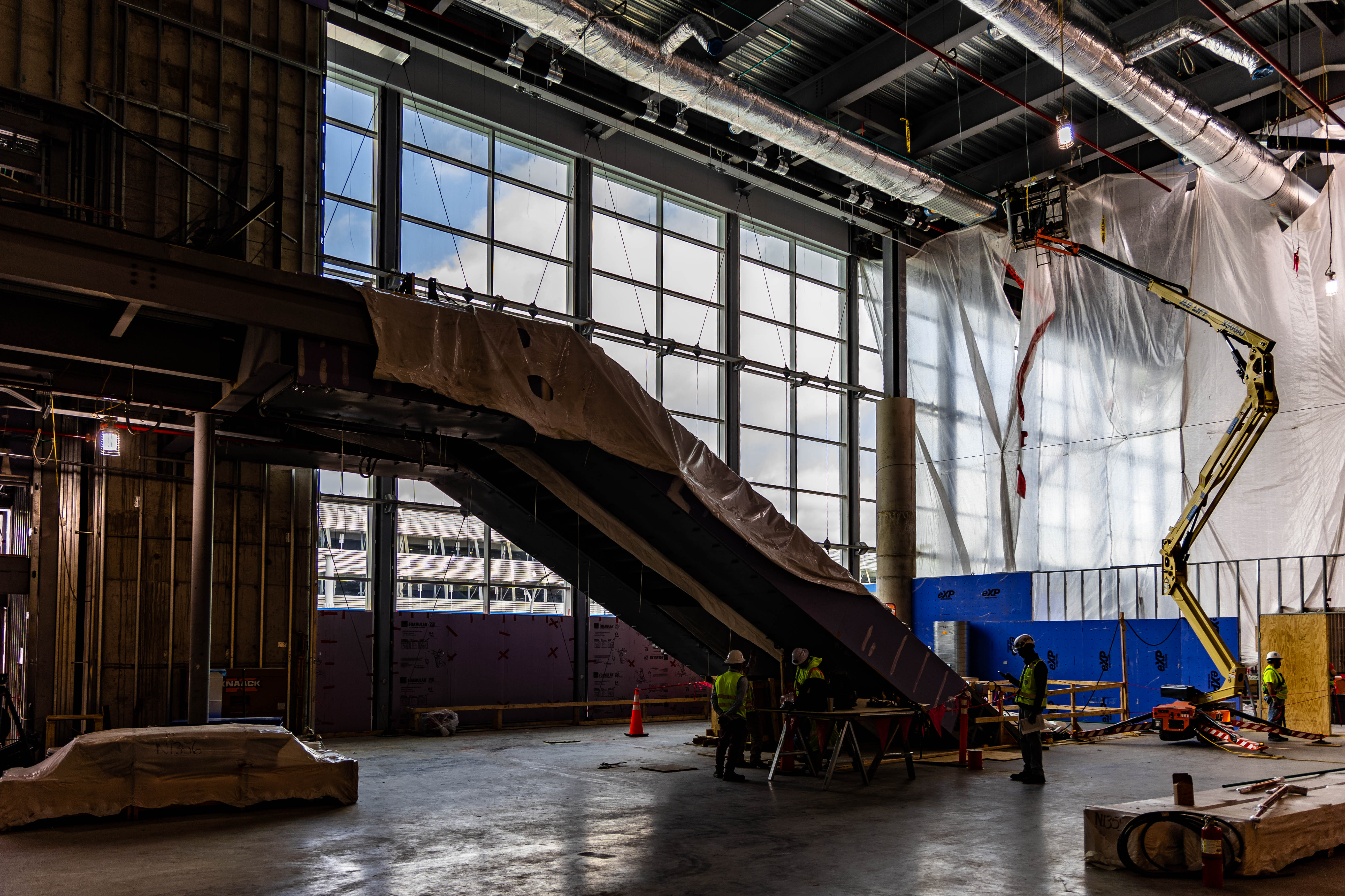 construction crews work on stairs in the east terminal lobby space 